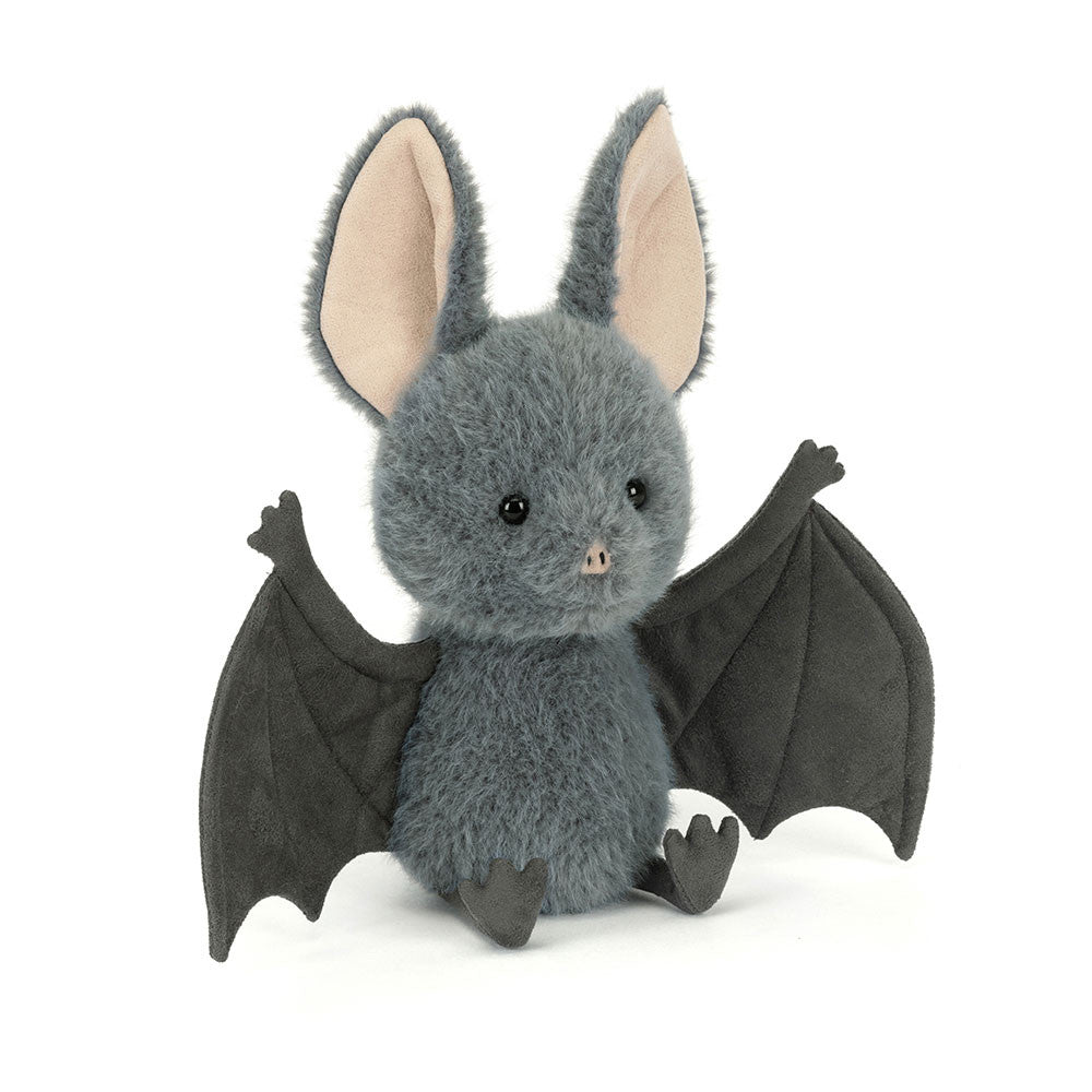 Jellycat Broox Bat plush toy on a white background, showing a round blue-grey fluffy body with large cream-lined ears, black hard eyes, a pink nose, dark outstretched wings, and small dark feet