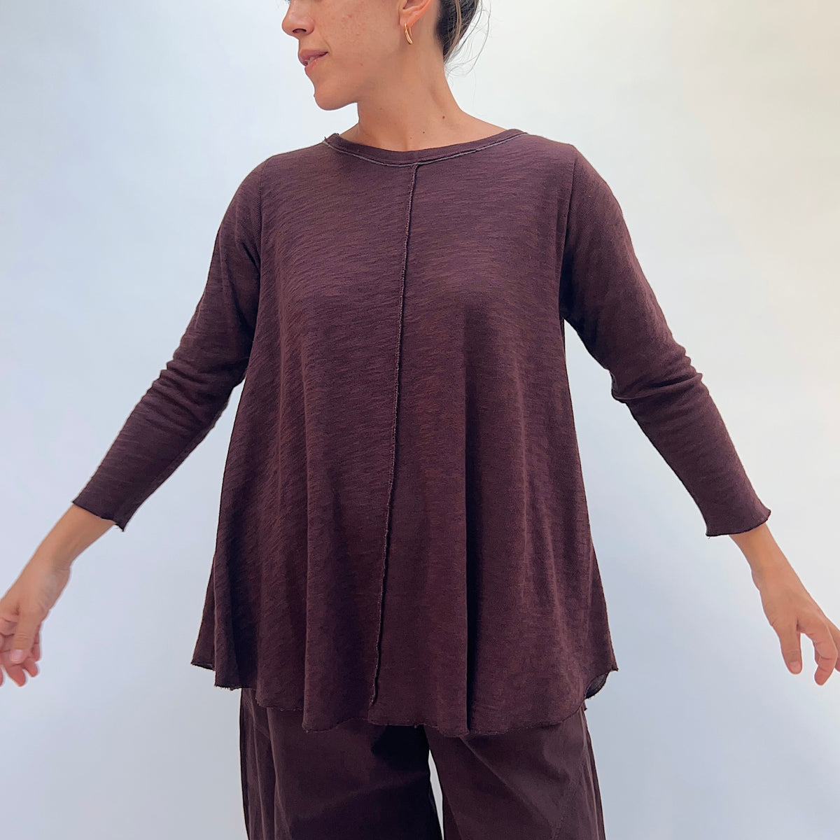 North Star Base Shorter High Low Double Cotton Tee in Chicory, front view showing the center front seam detail and raw-edge neckline in chicory brown
