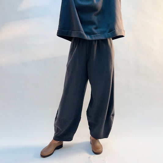 Front view of Bryn Walker Oliver Fleece Pant in Moonlight on a model, showing the loose legs tapering toward the ankles.
