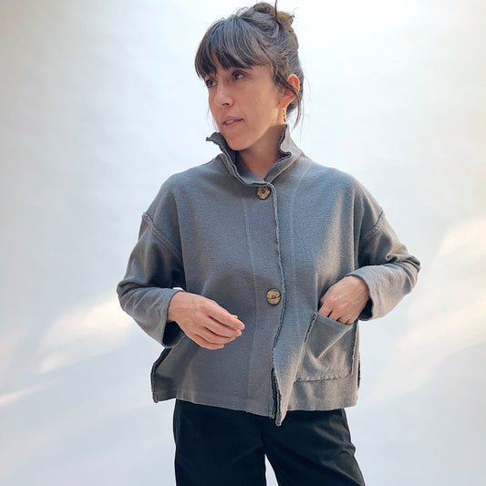 Eleven Stitch Funnel Jacket in Eiffel Tower, front view showing the funnel neckline, exposed seam detail, and front patch pockets in slate blue-gray cotton terry
