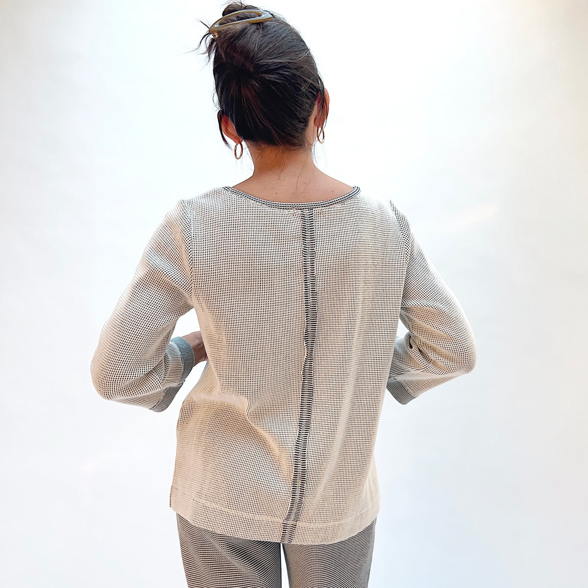 Habitat Opposites Attract Seamed Pullover in Winter White, back view showing the center back seam and wide contrast cuff in grid-textured thermal knit
