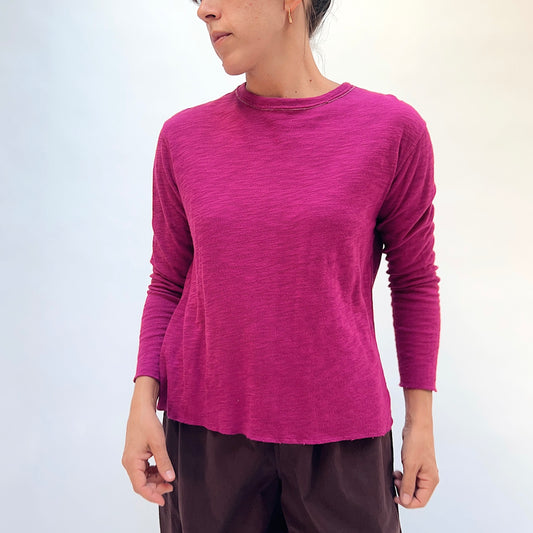 North Star Base Double Cotton Tee in Beet, front view showing the crew neck with raw-edge finish and slightly cropped sleeves in beet pink
