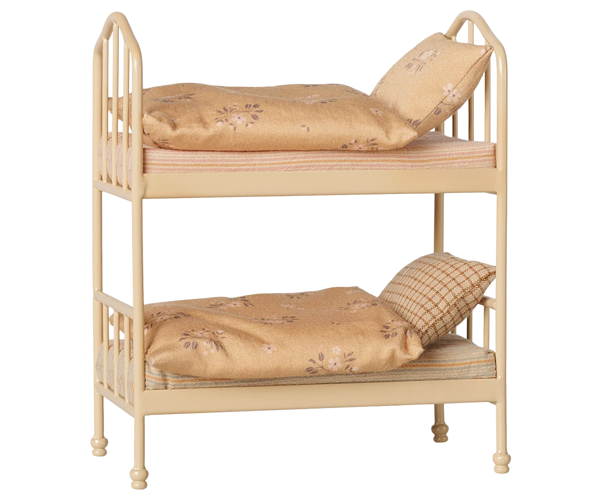Maileg Bunk Bed in Wheat — angled three-quarter view of miniature metal bunk bed in warm wheat finish with two floral cotton mattresses, soft blankets, and pillows on each bunk
