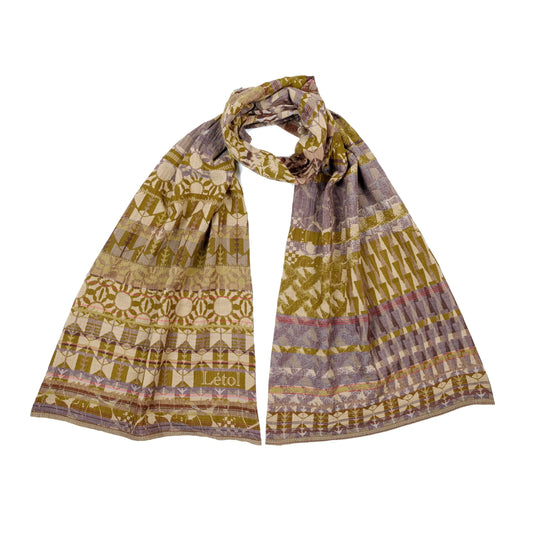 Létol Côme Scarf in Ambre & Souris, looped and laid flat against a white background showing both sides simultaneously — one side featuring bold geometric Art Deco bands of chevrons, stylized floral rosettes, and medallion motifs in amber and ochre on a warm beige ground with the woven Létol signature, the other showing the same pattern in a cool grey-taupe and honey colorway with brown accent bands
