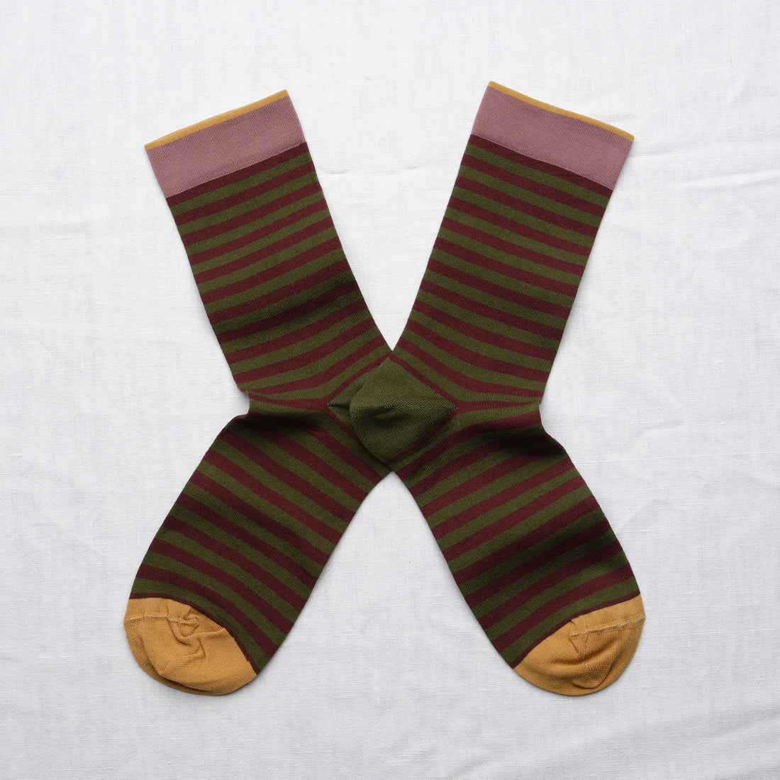 Bonne Maison Cypress Stripe Socks, flat lay pair showing horizontal stripes in cypress green and burgundy with a dusty pink cuff and mustard heel and toe
