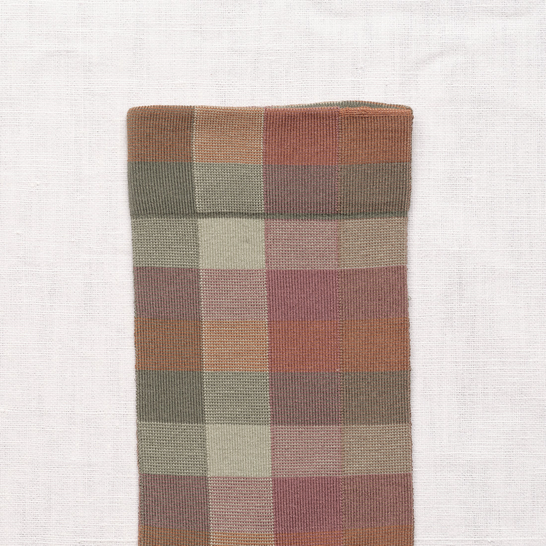 Bonne Maison Sunday Plaid Socks, close-up of the cuff showing the large-scale plaid weave in sage, dusty rose, terracotta, and cream
