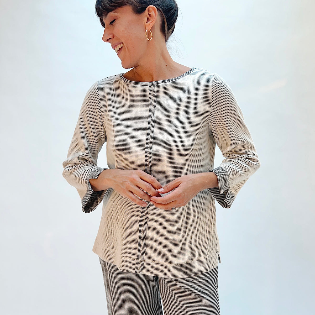 Habitat Opposites Attract Seamed Pullover in Winter White, front three-quarter view showing the relaxed fit, center seam, and contrast cuff detail in grid-textured thermal knit
