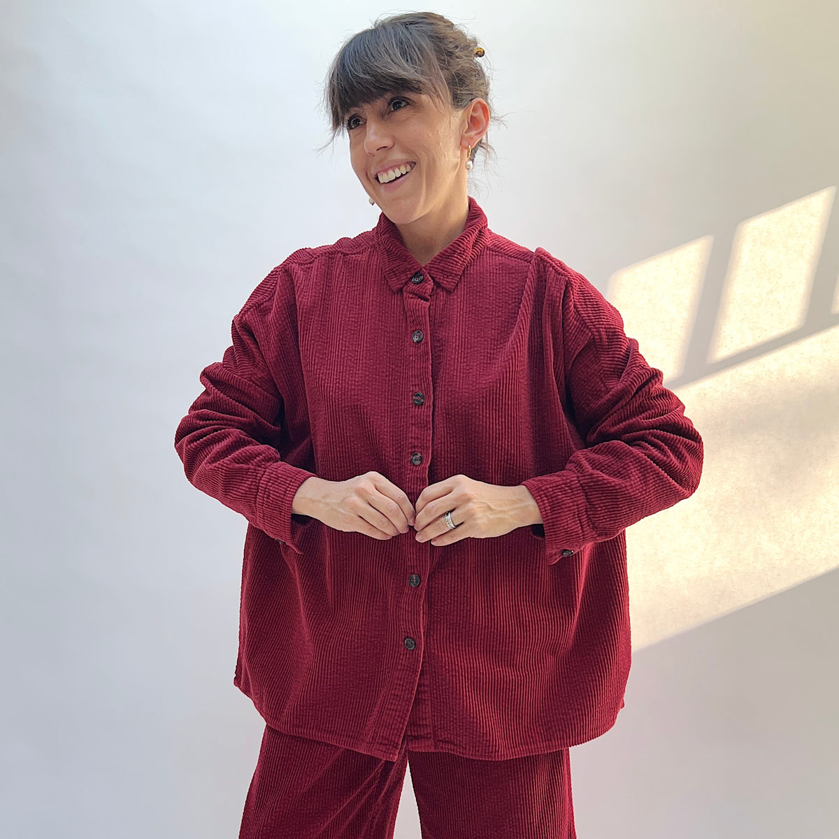 Front view of the Cut Loose Lux Corduroy Oversized Shirt in Maraschino on a model, showing the collar, button front, and corduroy texture.

