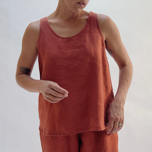 Front view of the Basic Tank in Terracotta by Yuvita — a cropped 100% linen scoop-neck tank in warm terracotta, styled with matching terracotta linen pants and gold hoop earrings