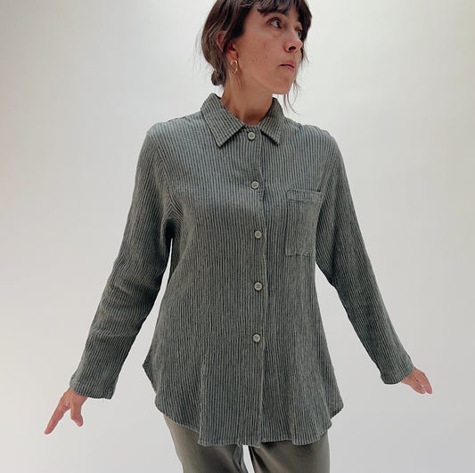 Front three-quarter view of model wearing Mill Valley Clothing Co olive boyfriend button-down shirt, showing point collar, chest pocket, and relaxed oversized fit