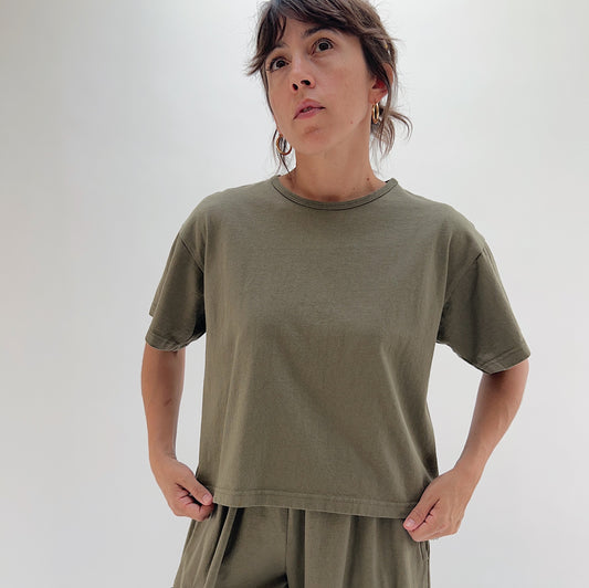 Front view of model wearing Pacific Cotton jasper crop crew tee, showing crew neckline with contrast stitching, boxy fit, short sleeves, and cropped hem