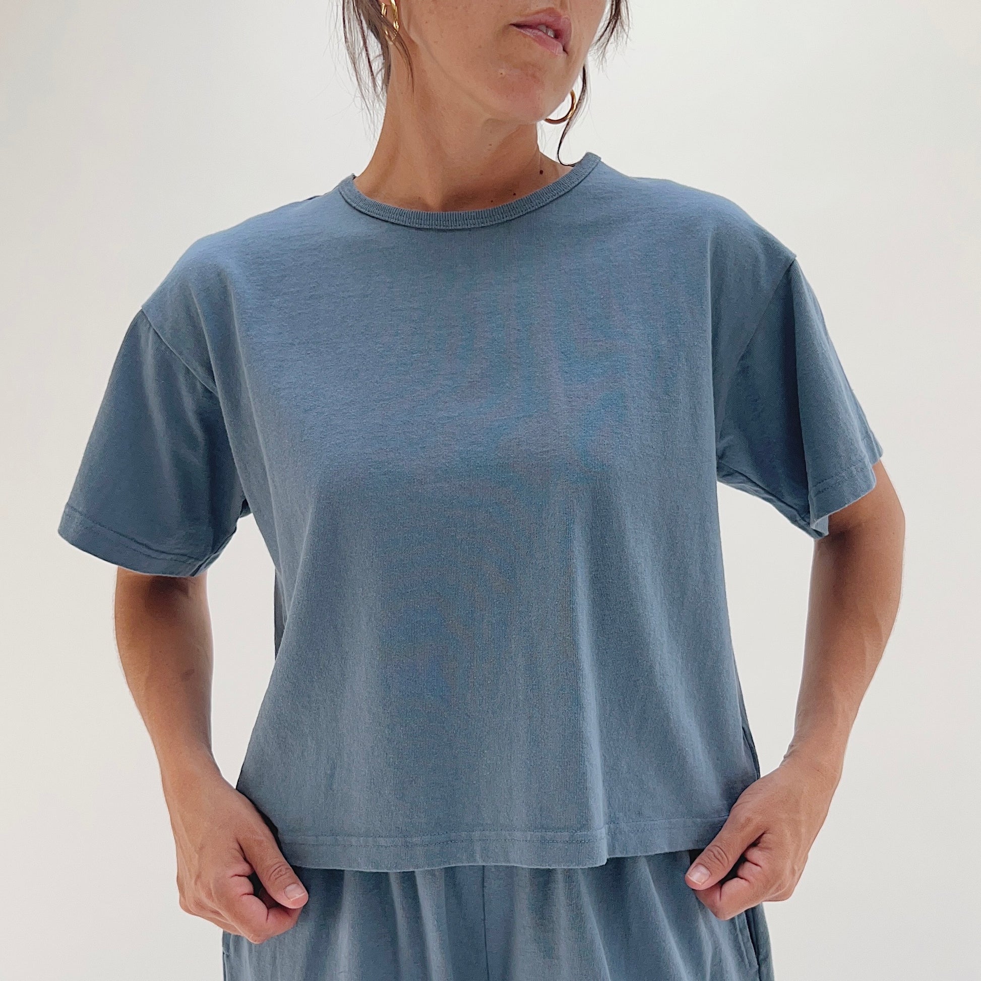 Full front view of model wearing Pacific Cotton vitznau crop crew tee, showing crew neckline, short sleeves, boxy fit, and straight cropped hem