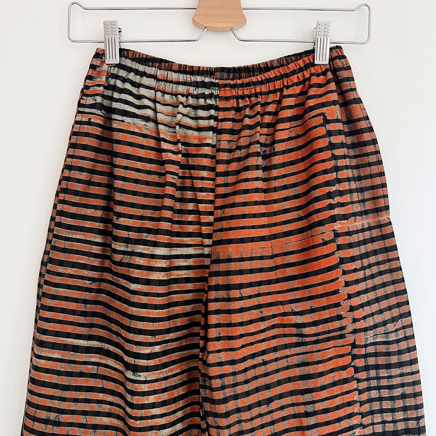 Detail of elastic waistband on Lazy Pants in Persimmon Grid, hand-dyed persimmon orange and black batik stripe cotton fabric
