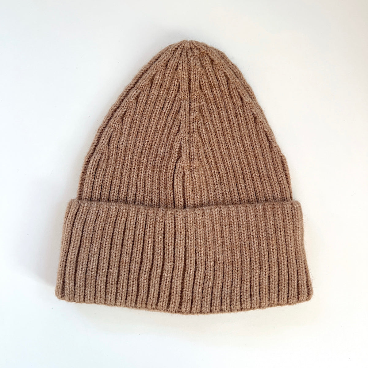 Toast brown ribbed lambswool beanie laid flat with a wide fold-over cuff.
