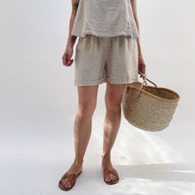 Load image into Gallery viewer, Person wearing a gray t-shirt and shorts holding a woven basket on a white background
