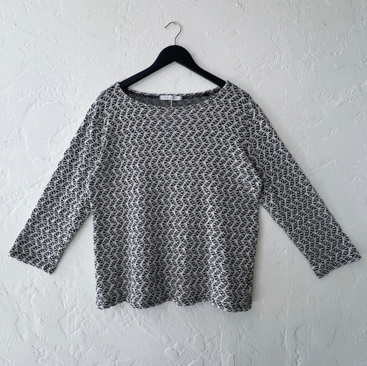 Cut Loose Wavy Crochet Knit 3/4 Sleeve Boatneck Top in Laundered, front view on hanger, black and white wavy diagonal crochet knit pattern with boatneck and 3/4 sleeves
