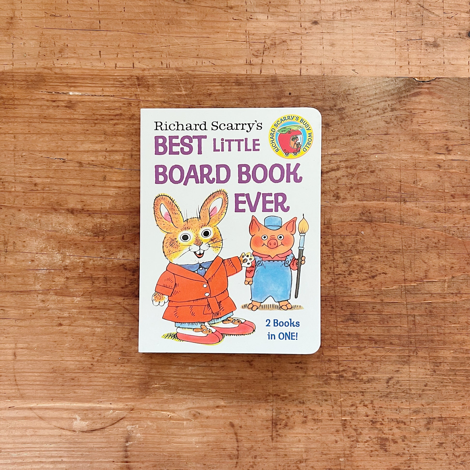 Front cover of Richard Scarry's Best Little Board Book Ever, a 2-in-1 board book published by Golden Books, featuring a white background with the title in bold purple and mixed-case lettering. Frannie the bunny — a large brown rabbit in a red coat and red shoes — stands on the left with her arm around Mr. Paint Pig, a small pink pig in blue overalls and a blue cap holding a large paintbrush. A "2 Books in ONE!" callout appears in the lower right, and the Richard Scarry's Busy World circular badge is in the 
