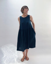 Load image into Gallery viewer, Woman wearing a navy sleeveless dress against a white background
