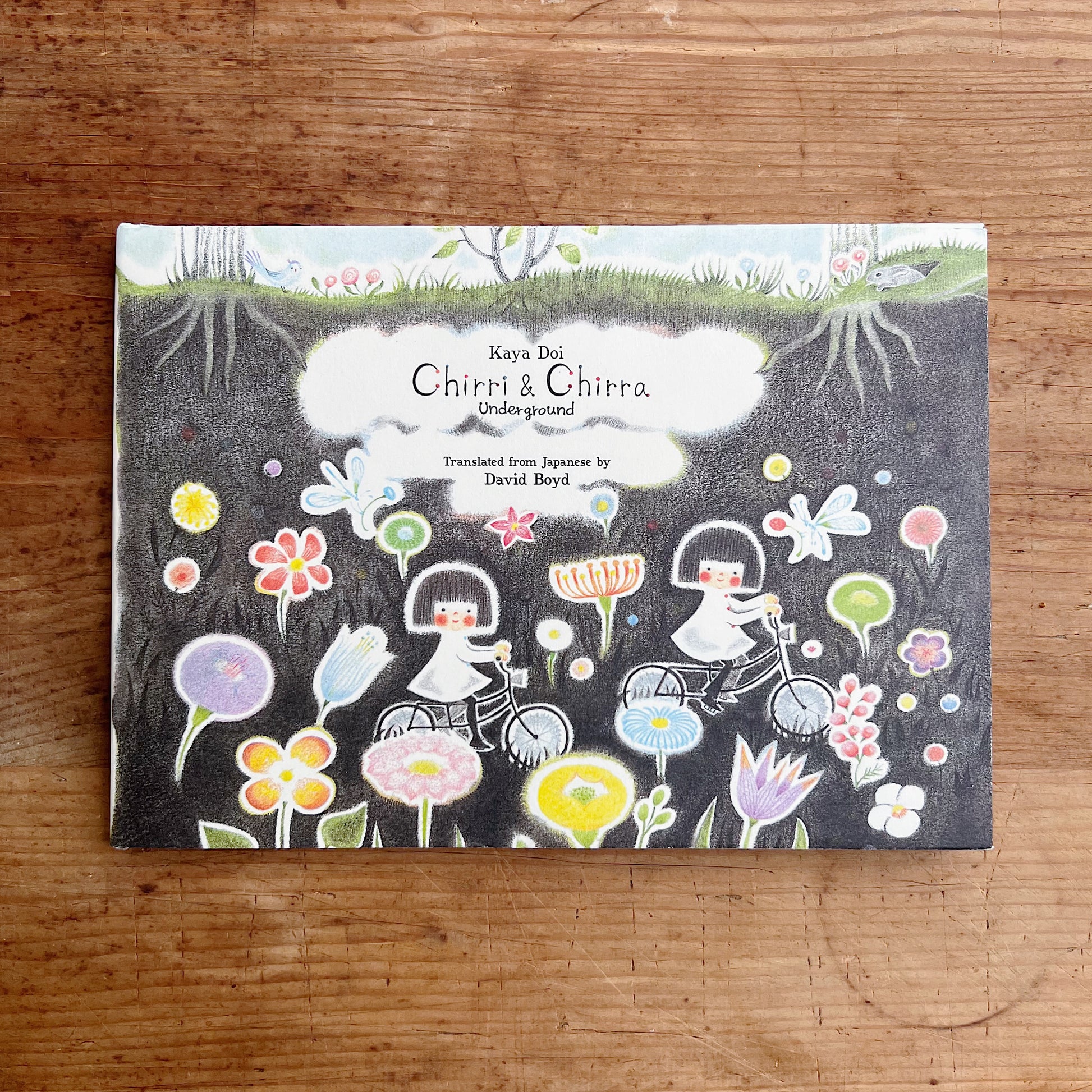 Cover of 'Chirri & Chirra: Underground' featuring illustrations of nature and magical elements such as flowers, roots, and moles.