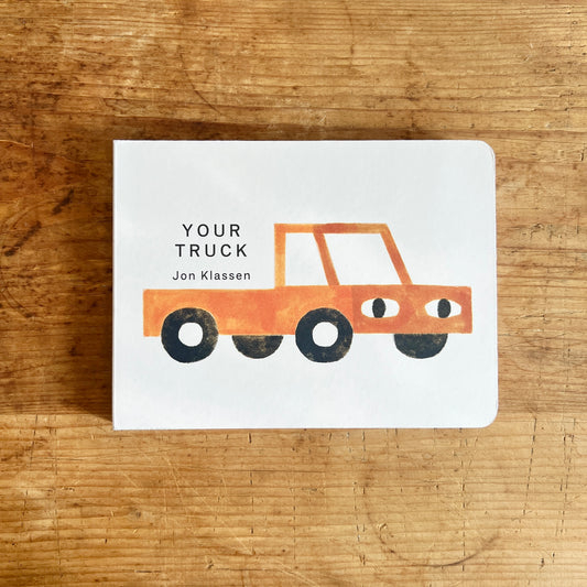 Cover of Your Truck by Jon Klassen, showing an orange-red pickup truck with eyes on a white background.
