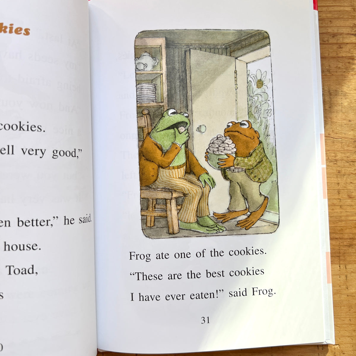 Open page of Frog and Toad Together showing Frog eating a cookie while Toad holds a bowl piled with cookies.

