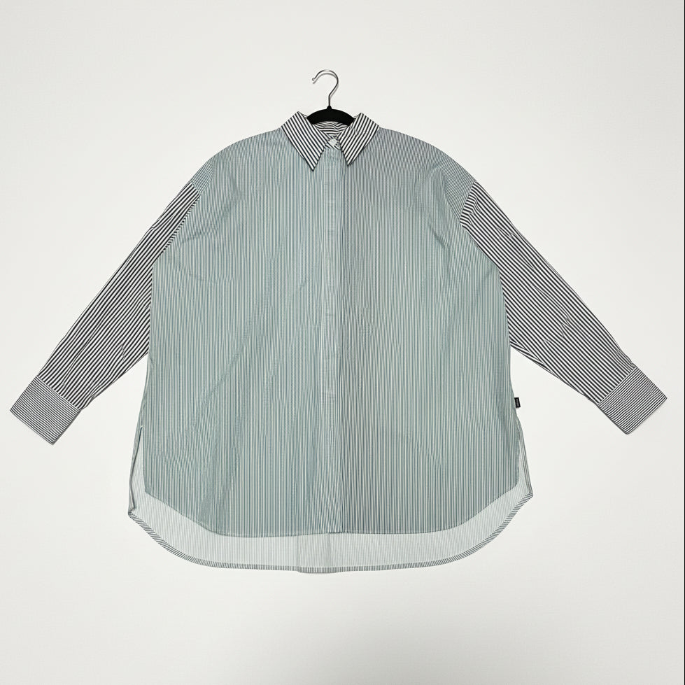 Striped shirt on a hanger against a white background