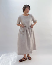 Load image into Gallery viewer, Woman wearing a subtle pinstripe linen dress against a white background
