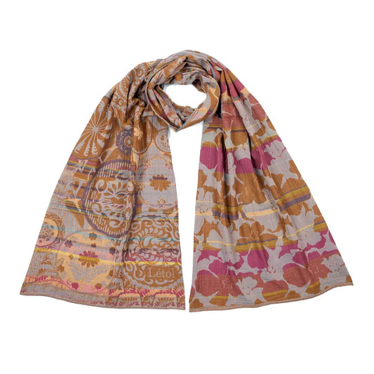 Létol Lexi Scarf in Ocre & Fuschia, looped and laid flat against a white background showing both sides simultaneously — one side featuring a playful mix of geometric medallions, sunburst rosettes, scrollwork, and folk motifs in ochre, gold, and mauve on a warm taupe ground with the woven Létol signature, the other showing a bold large-scale fuchsia, pink, and ochre poppy and floral silhouette pattern on a pale taupe ground with gold accent bands
