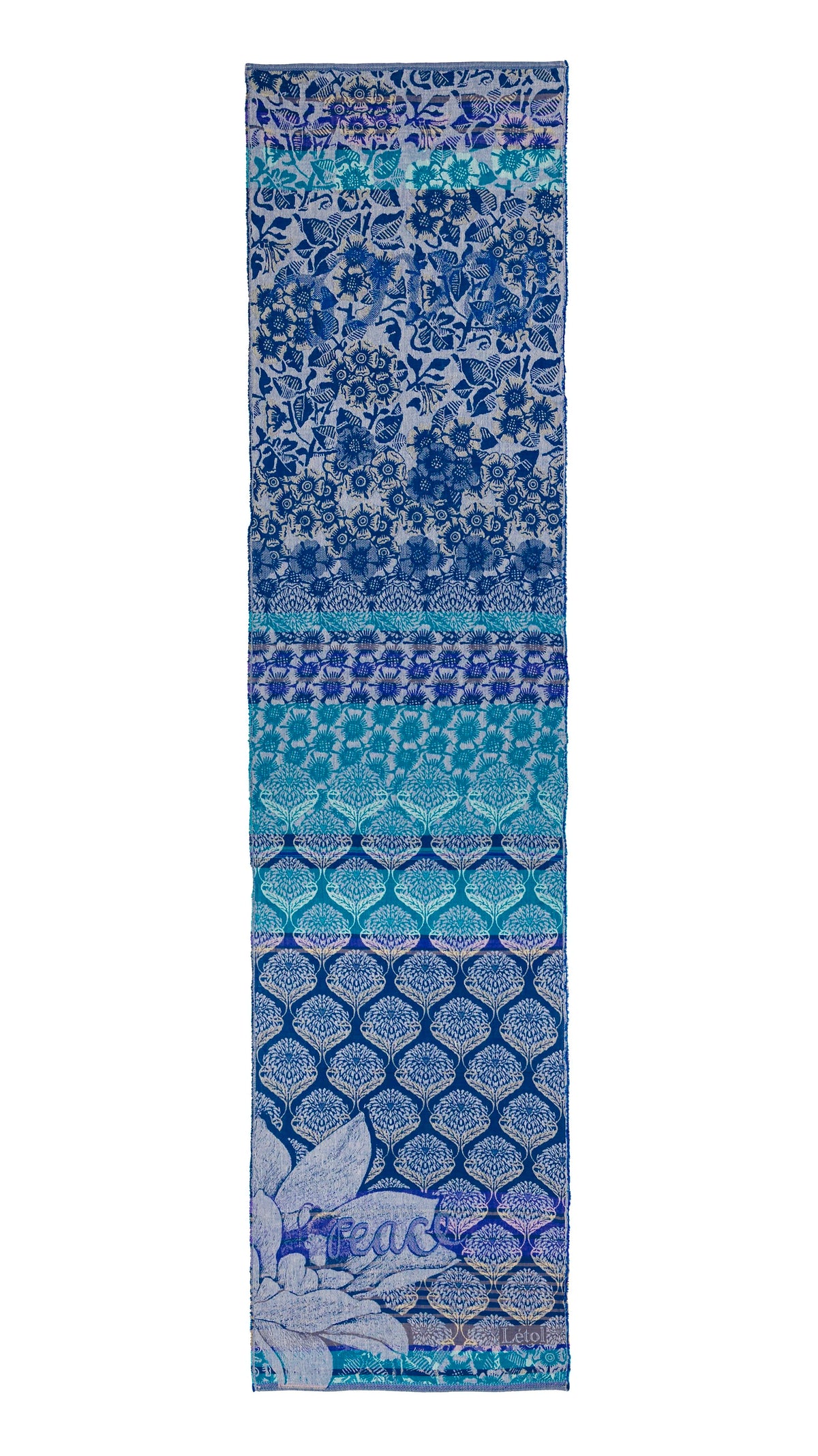 Létol Louise Scarf in Crépuscule Night Blue, laid flat and fully extended against a white background, showing the full length of the scarf with a dramatic gradient composition — the top third in a dense indigo floral and bird print on light blue, transitioning through a turquoise geometric sunflower band, then a teal ogee lattice zone, deepening into a rich navy tree-of-life ogee pattern at the base with a large Jacquard-woven botanical motif and the Létol signature in the lower corner
