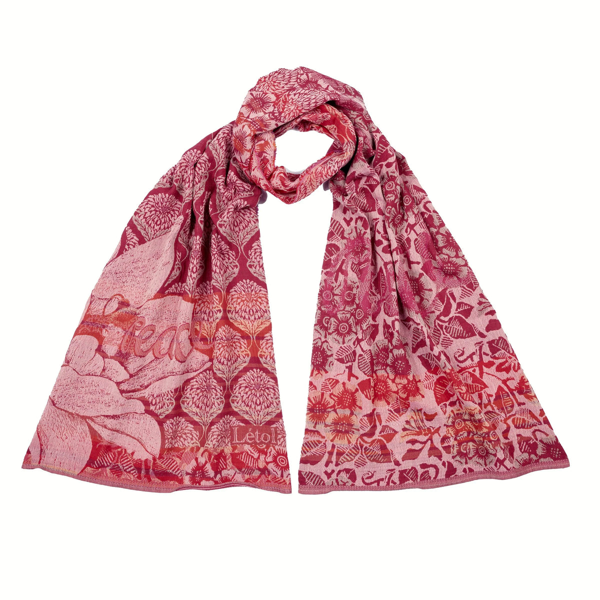 Létol Louise Scarf in Ispahan Pink, draped and loosely knotted against a white background, showing a reversible Jacquard-woven organic cotton scarf in Indian pink, fuchsia, rose, and bright red — one side featuring large botanical rose and chrysanthemum motifs in a damask lattice, the other showing a dense all-over floral and bird pattern — with a woven Létol label visible at
