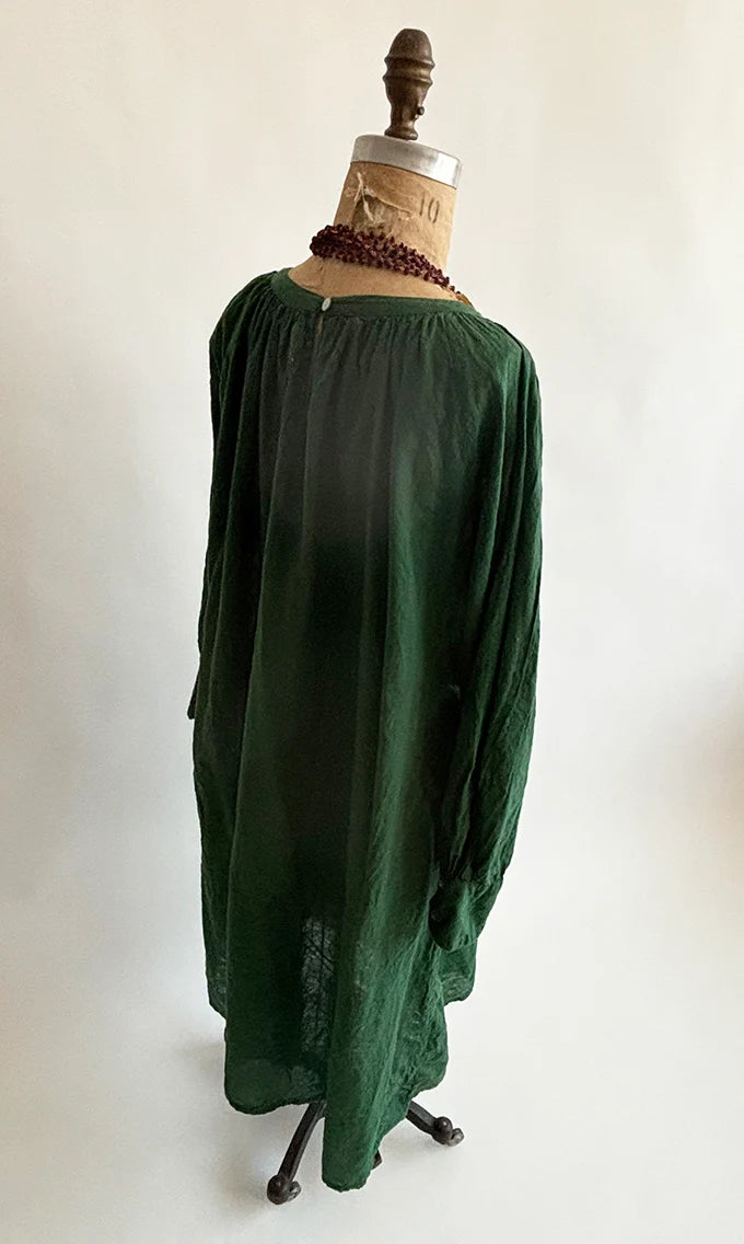 Back view of Olive Gathered Dress on a dress form, showing the neck button closure and soft gathers.
