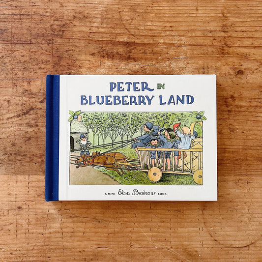 Front cover of mini version of Elsa Beskow's Peter in Blueberry Land. Illustration shows a group of boys riding in a cart pulled by mice.