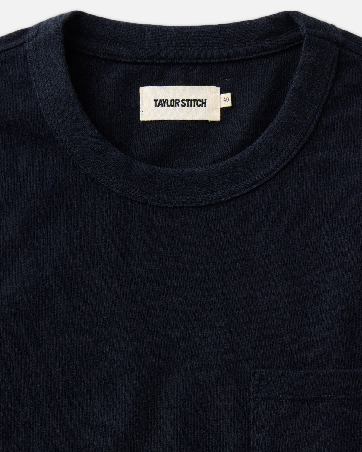 Close-up of the Long Sleeve Shop Tee in Navy Twist, showing the crew neckline, Taylor Stitch label, and top of the chest pocket.
