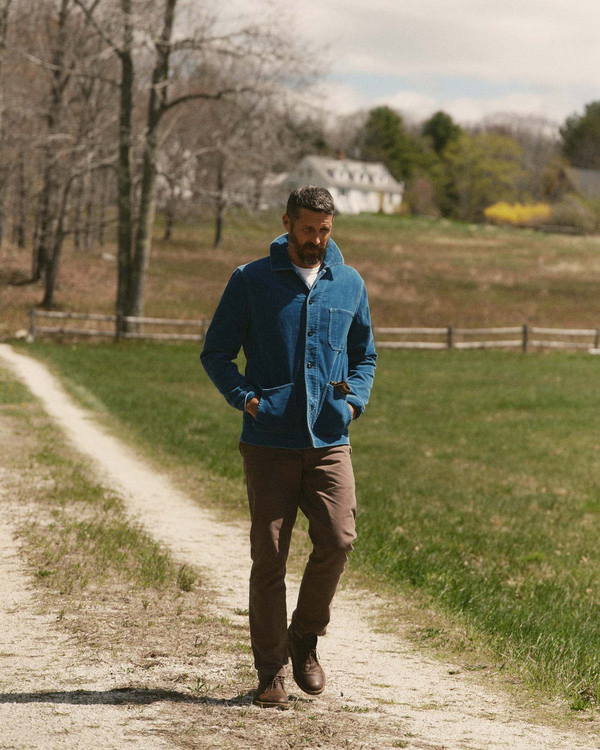 Model wearing the Ojai Jacket in Washed Indigo Corduroy outdoors, with hands in the lower pockets.
