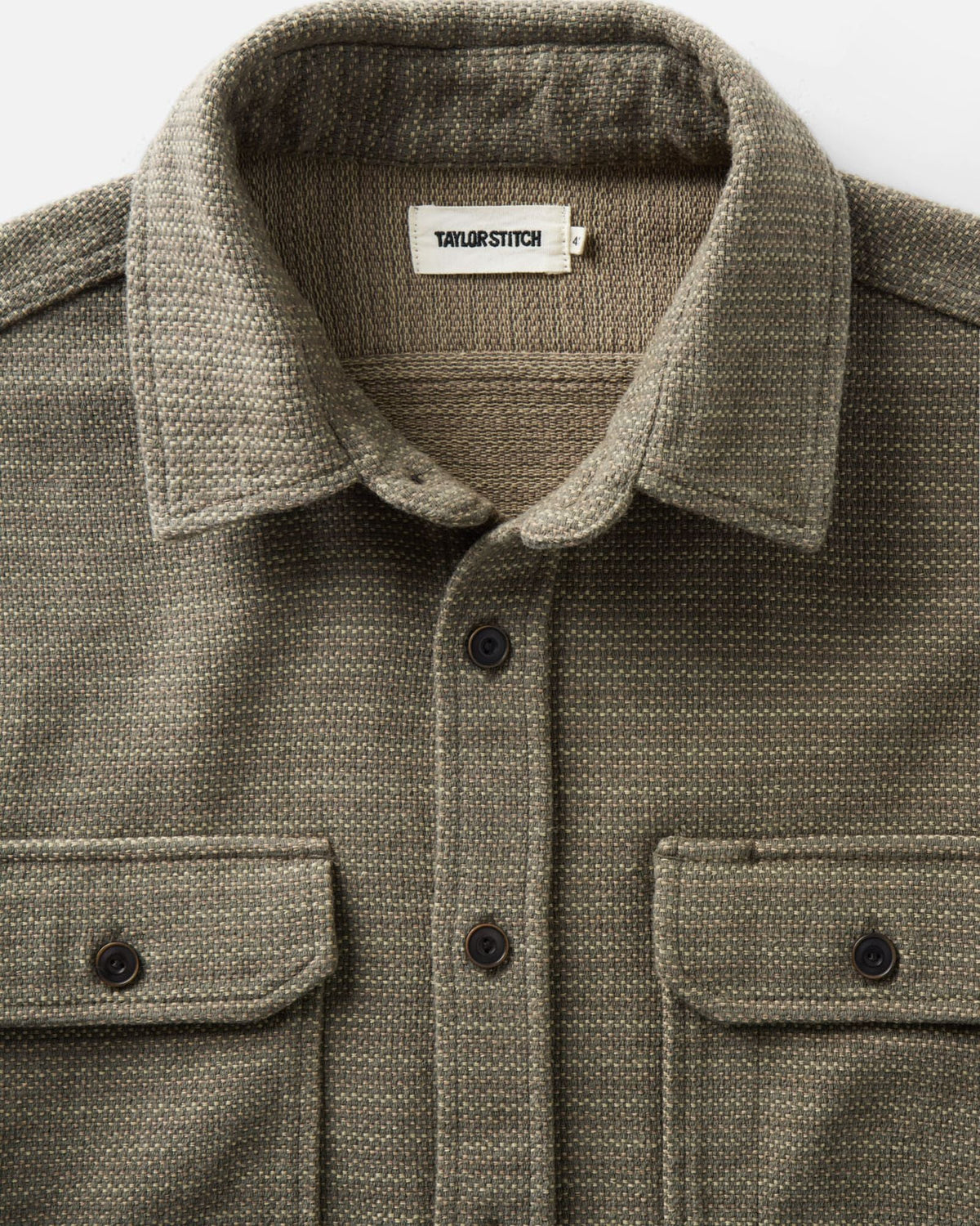 Close-up of the Division Shirt in Cypress, showing the collar, Taylor Stitch label, textured sashiko fabric, and chest pocket flaps.
