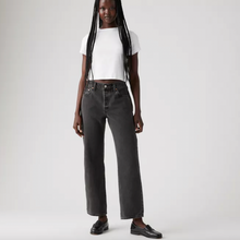 Load image into Gallery viewer, Person wearing black high-waisted jeans and a white top on a plain background
