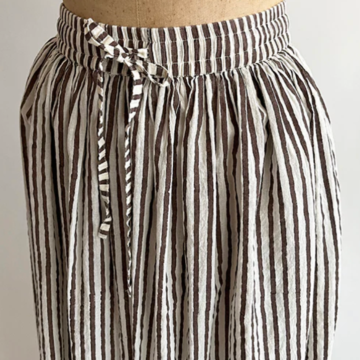 Striped pants on a mannequin against a plain background
