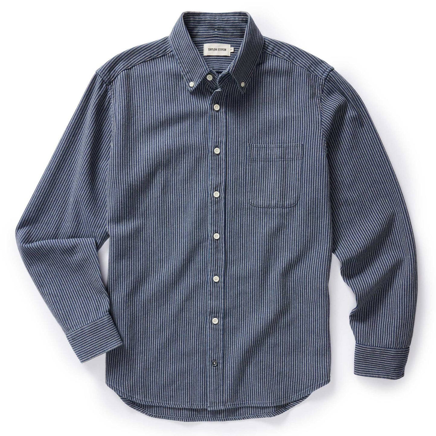 Flat lay of The Jack in Roped Indigo by Taylor Stitch — a long-sleeve button-down Oxford shirt in navy roped indigo with a chest pocket and button-down collar, on a white background