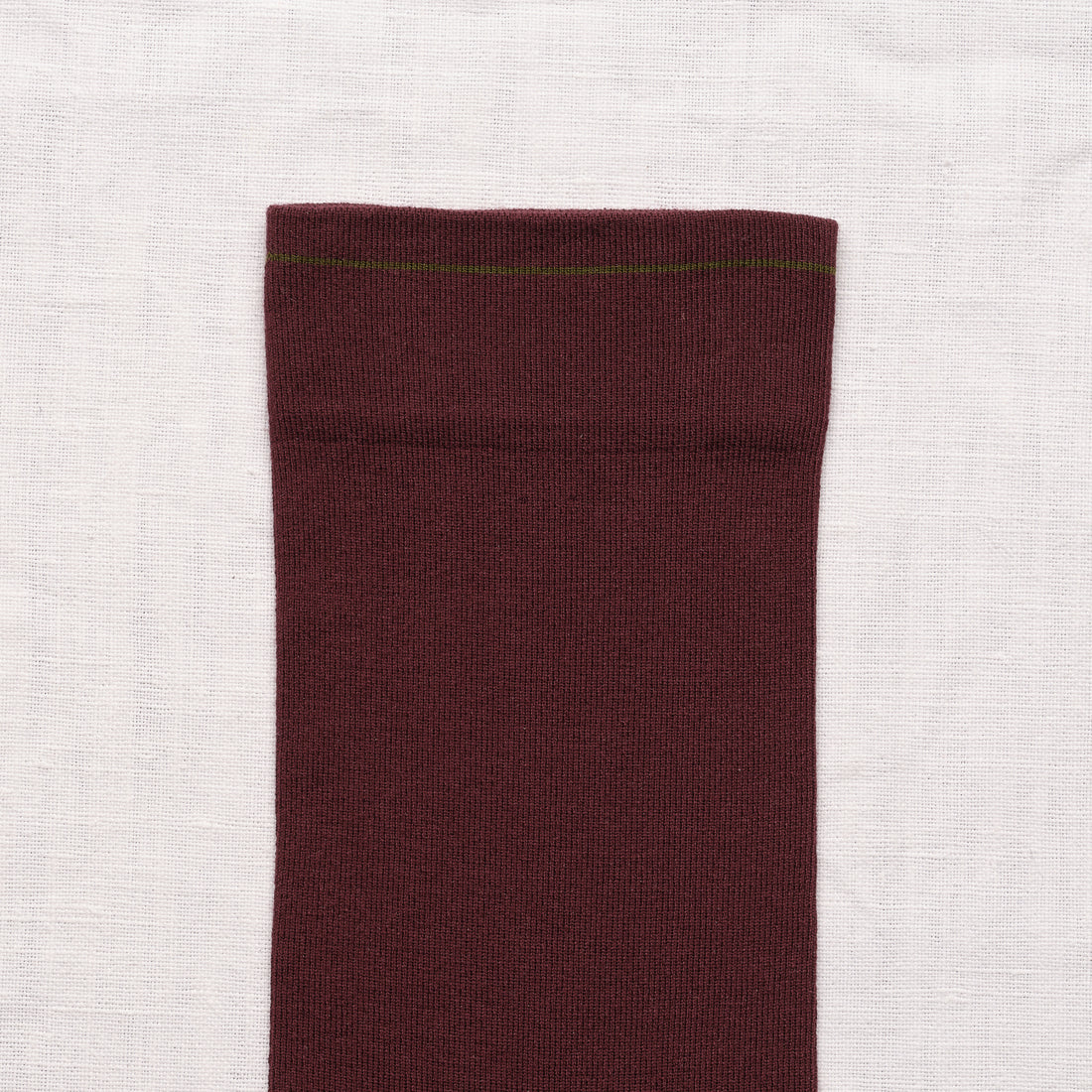 Bonne Maison Solid Burgundy Socks, close-up of the cuff showing the solid burgundy body with thin olive stripe at the top
