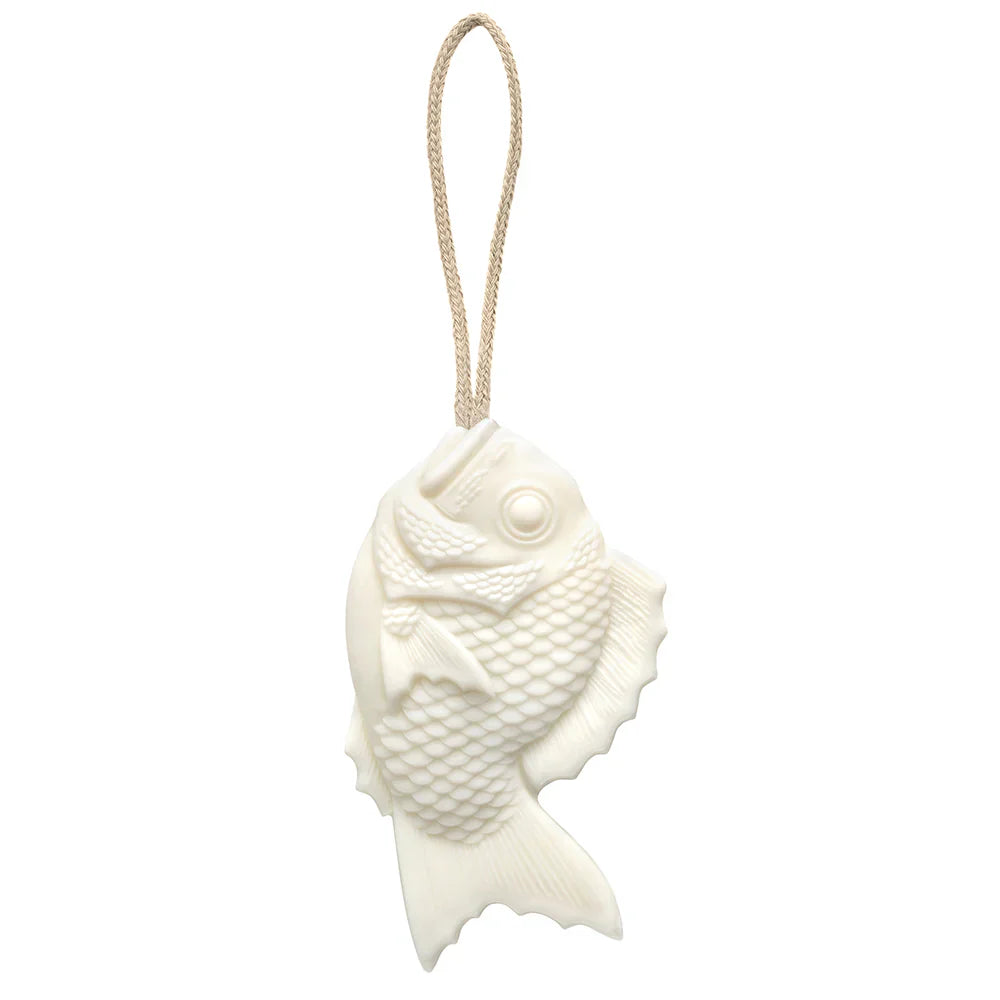 Tamanohada Lily Welcome Soap in the shape of a Japanese bream fish, white plant-based soap with detailed scale texture, hanging from a natural braided linen rope — product view on white background
