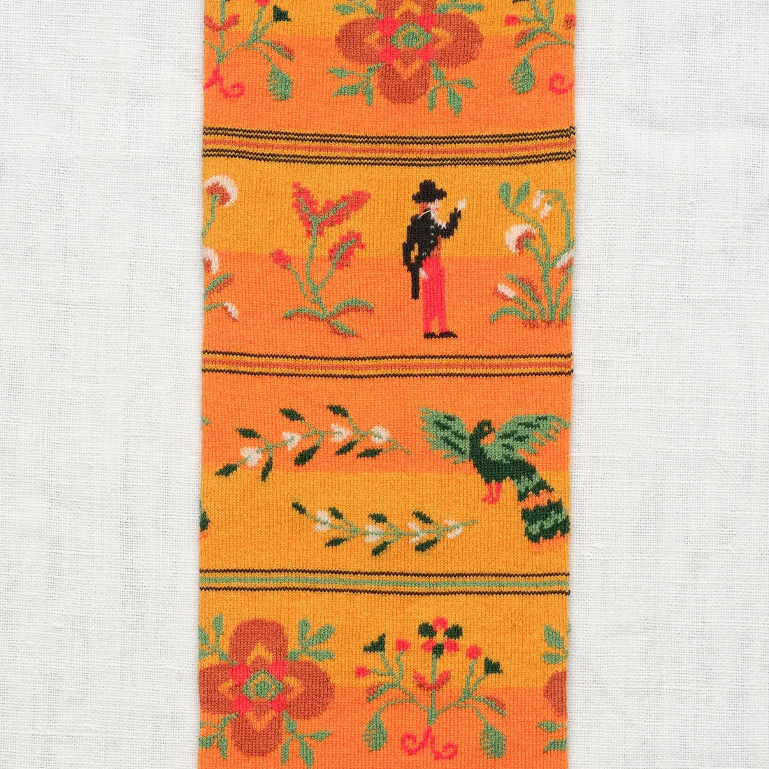 Bonne Maison Amber Character Knee High Socks, close-up showing the folk-style character, bird, and floral motifs in the horizontal stripe bands
