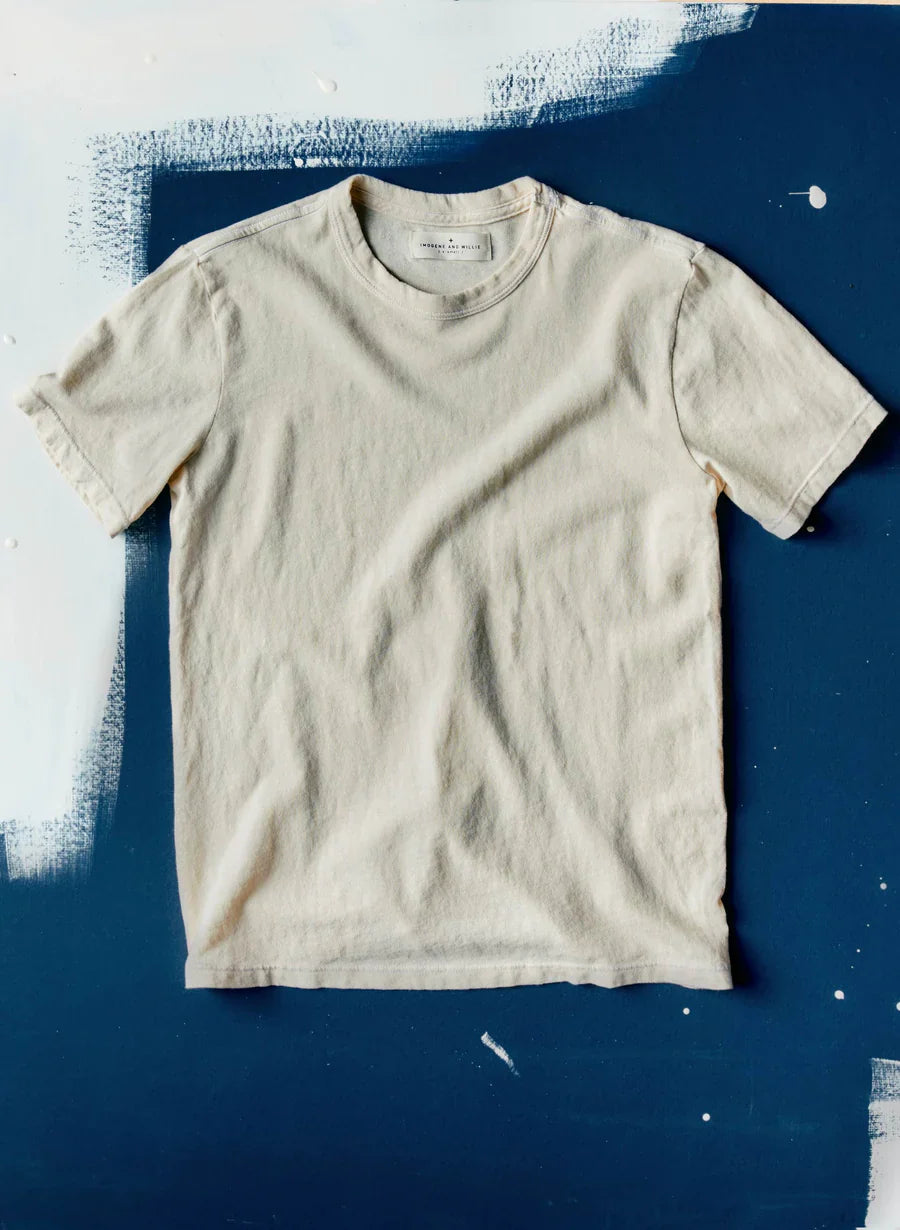 Imogene + Willie Classic Knit Midweight Crew in Vintage White, short-sleeve crewneck t-shirt laid flat on a painted navy blue surface — overhead product shot
