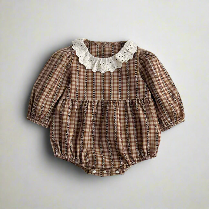 Brown checkered baby romper with lace collar on a light gray background