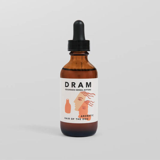 DRAM Colorado Herbal Bitters Hair of the Dog Aromatic Bitters 2 oz amber glass dropper bottle with illustrated label featuring overlapping faces in terracotta tones, against a light grey background