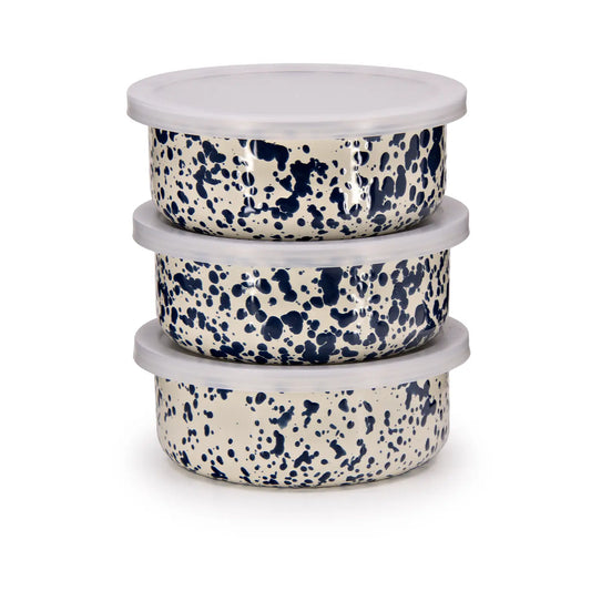 Stack of three ceramic bowls with blue speckled pattern on a white background