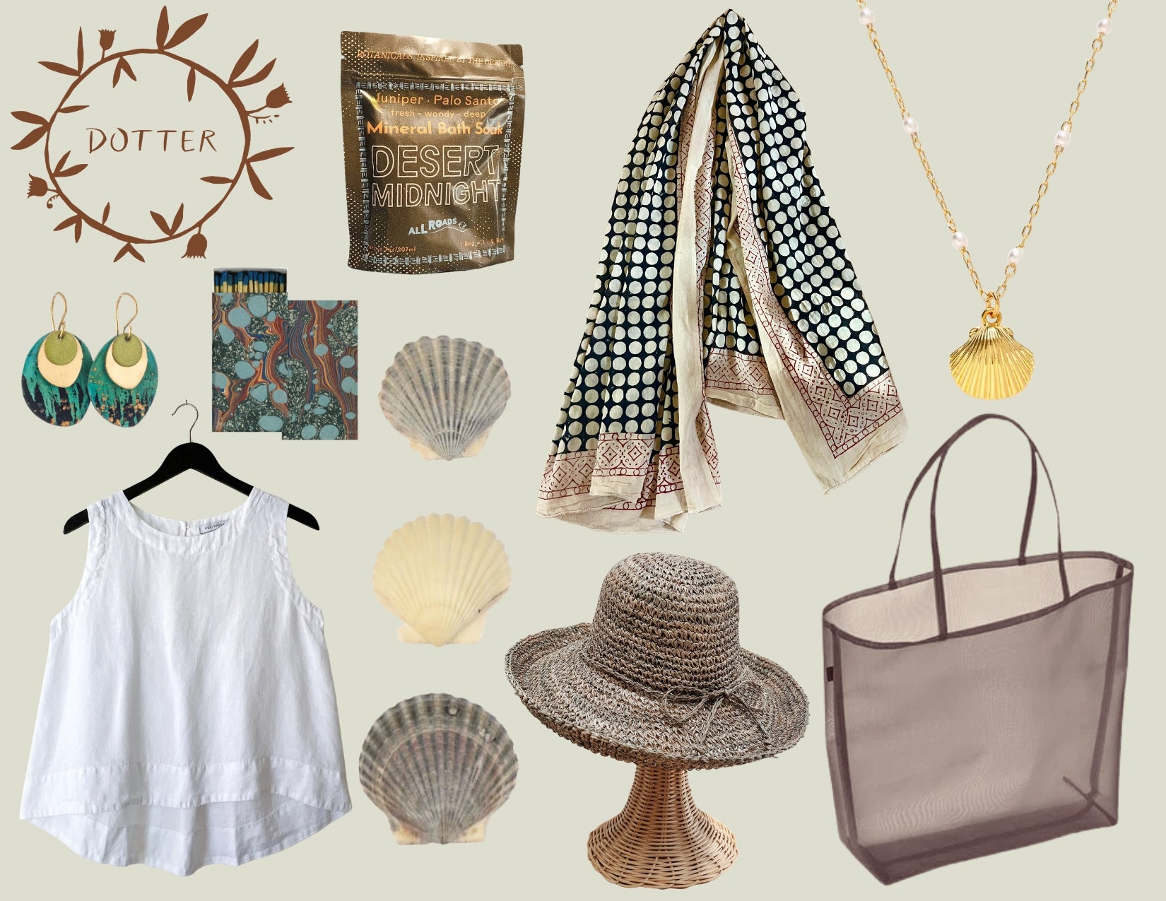 A flat-lay collage of multiple accessories on a light beige background including a white linen tank top on a hanger, a black-and-white patterned sarong, a gold shell pendant necklace, a rattan woven hat on a stand, shell images, a marbleized paper matchbox, a sachet of bath salts with the words Desert Midnight printed on the bag, and a brown mesh tote bag. The word 'DOTTER' appears in a leafy circular logo at upper left.