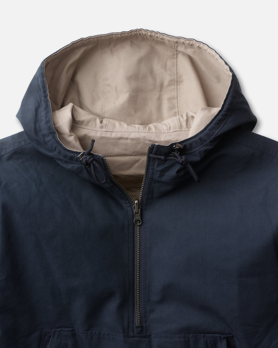Navy blue jacket with beige interior on a light gray background