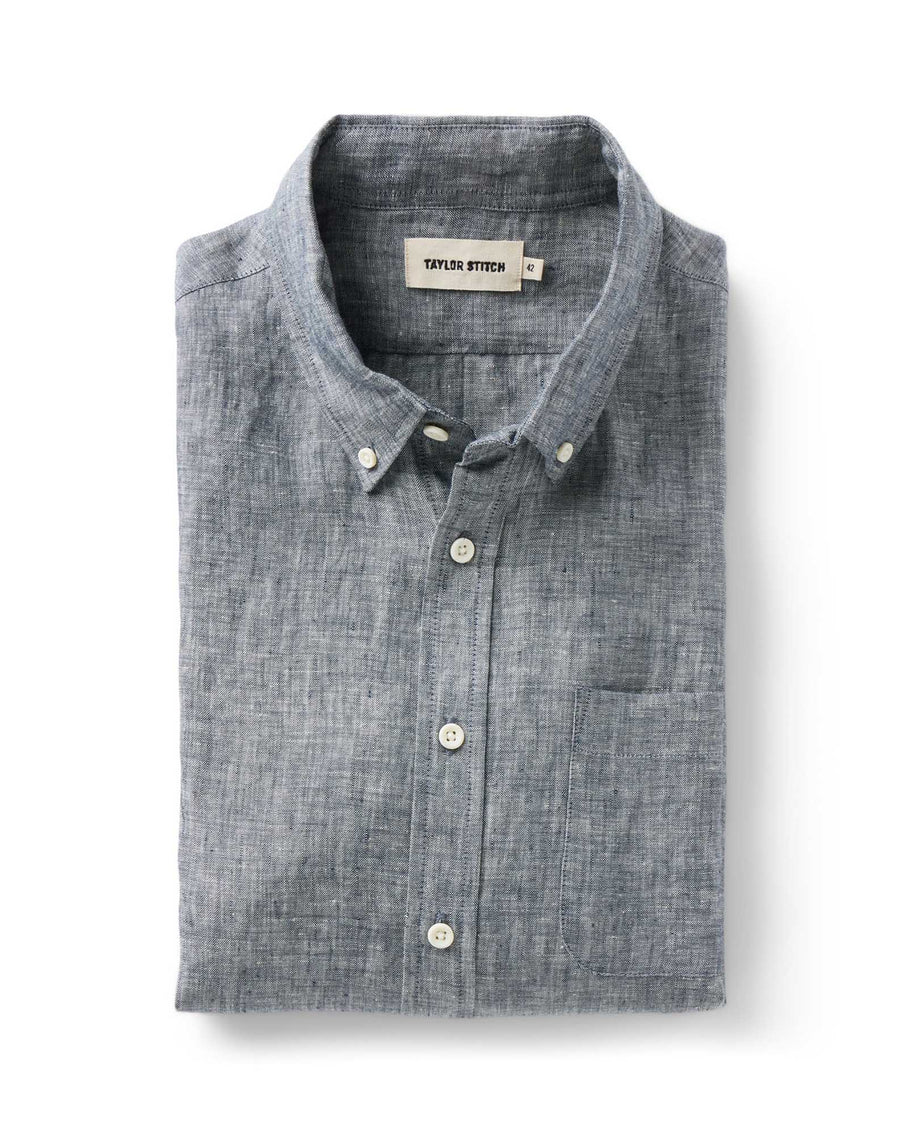 Taylor Stitch The Jack shirt in Ocean Linen folded flat, showing ocean blue-grey washed European linen, button-down collar with lock-stitched buttons, and single rounded chest pocket
