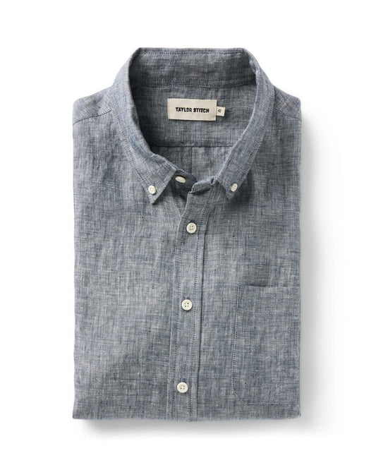 Taylor Stitch The Jack shirt in Ocean Linen folded flat, showing ocean blue-grey washed European linen, button-down collar with lock-stitched buttons, and single rounded chest pocket
