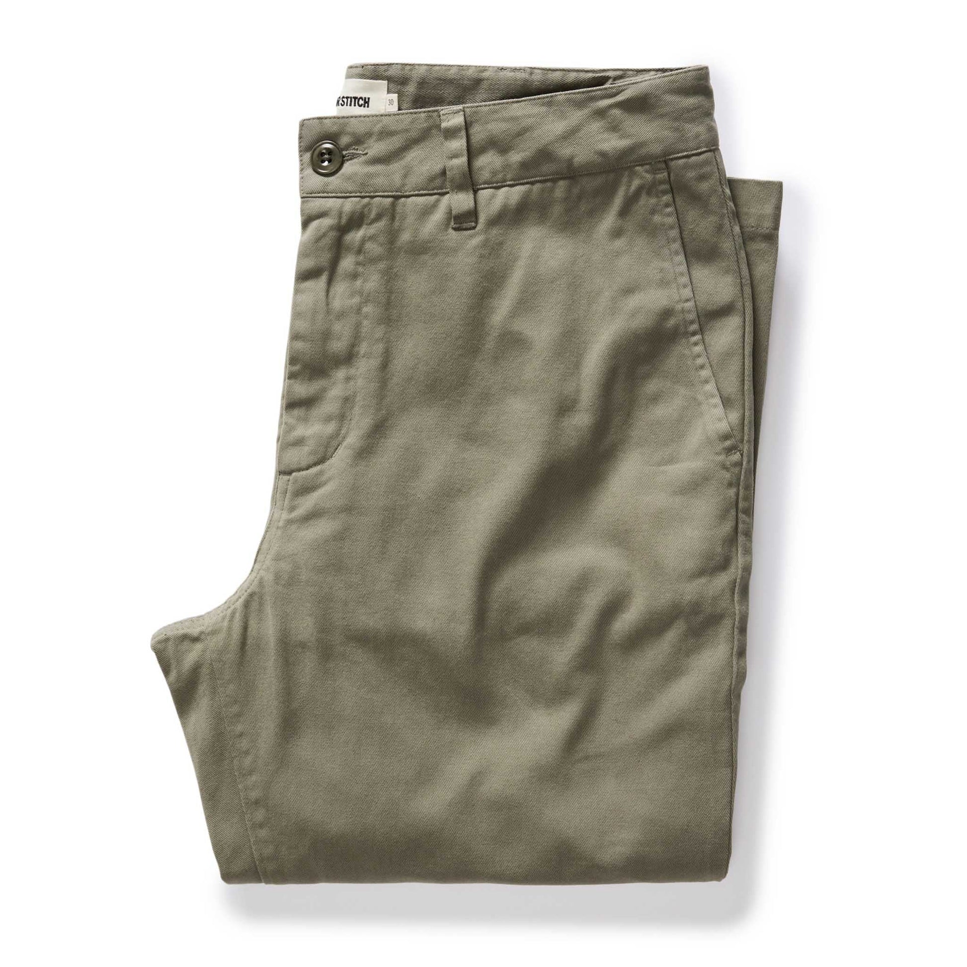 A pair of folded olive green chino pants on a clean white background.